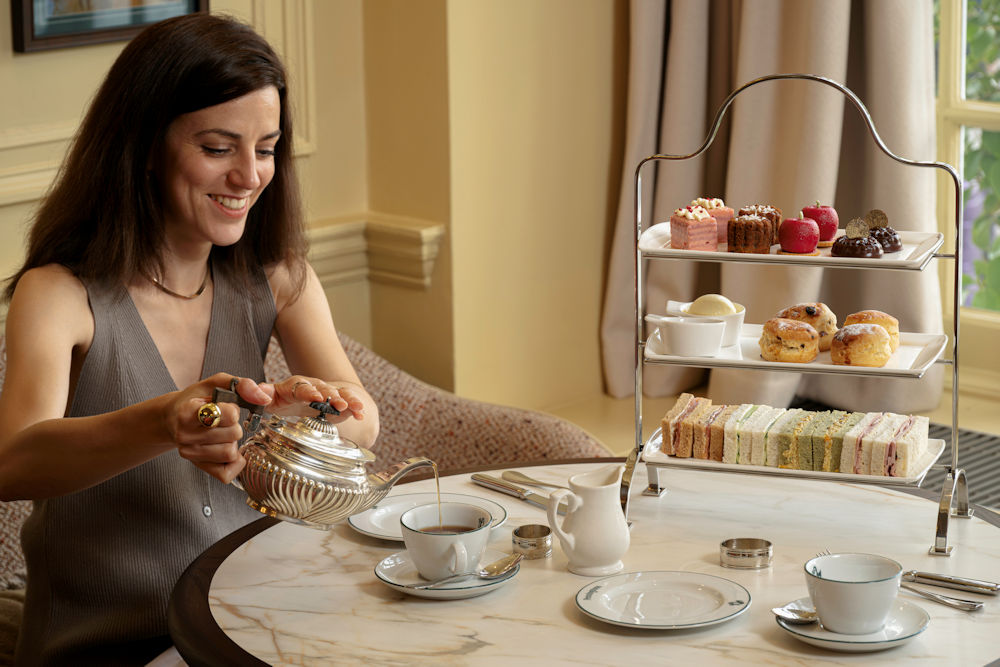 Person pouring tea at Penningtons, Castle Hotel Windsor